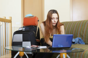 Woman reserving hotel online in the internet